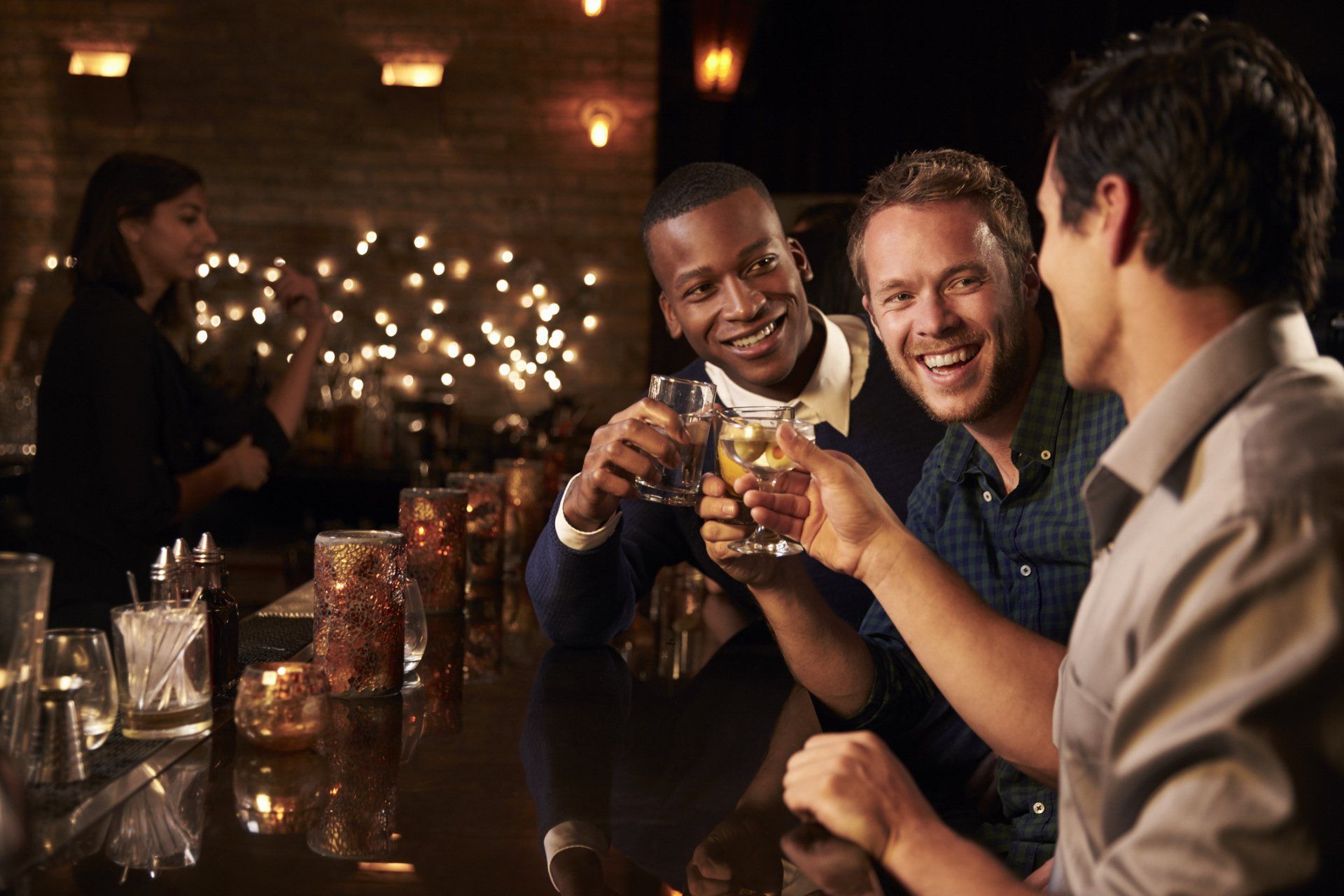 Friends toasting at a bar.